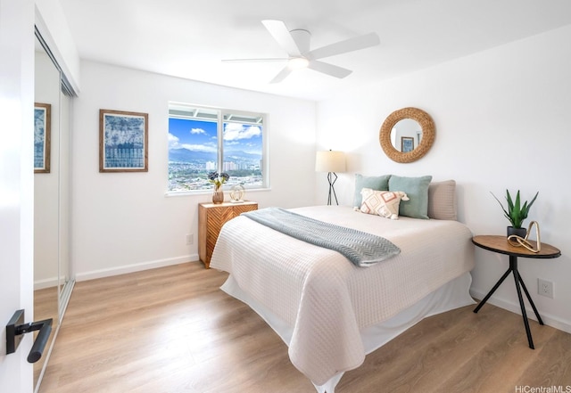 1129 Ala Aloalo St, Honolulu, HI 96818 - bedroom featuring light wood-style floors, baseboards, and ceiling fan