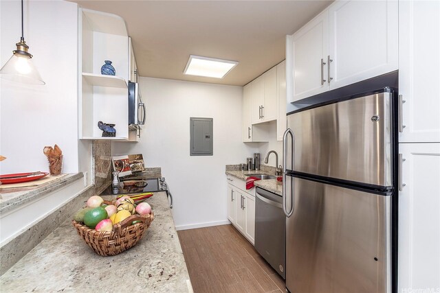 kitchen featuring a sink, open shelves, electric panel, light wood-style floors, and stainless steel appliances