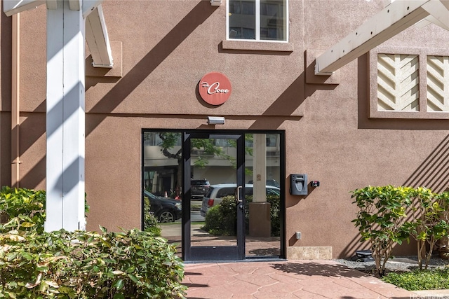 doorway to property with stucco siding