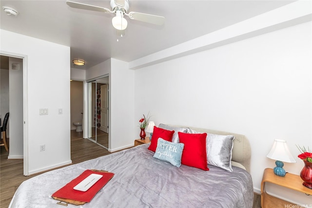 bedroom with a closet, wood finished floors, baseboards, and ceiling fan
