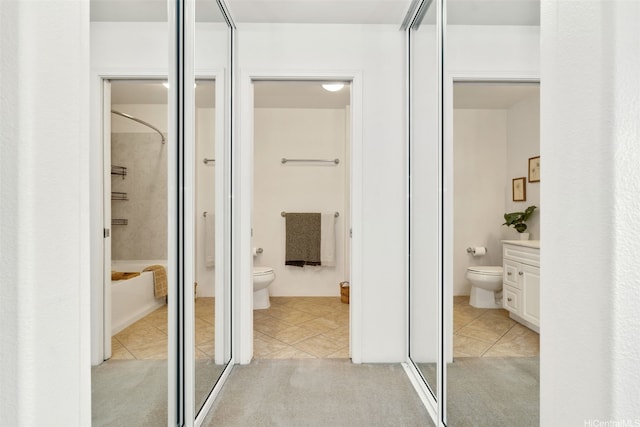bathroom featuring toilet, vanity, tile patterned floors, and a shower
