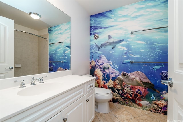 bathroom with toilet, vanity, tile patterned floors, and curtained shower