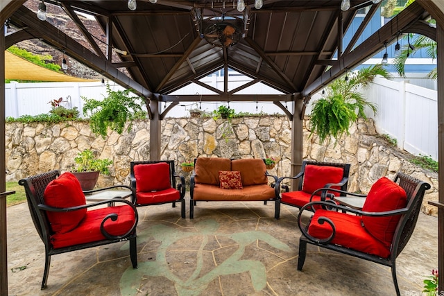 view of patio / terrace with a gazebo, outdoor lounge area, and a fenced backyard