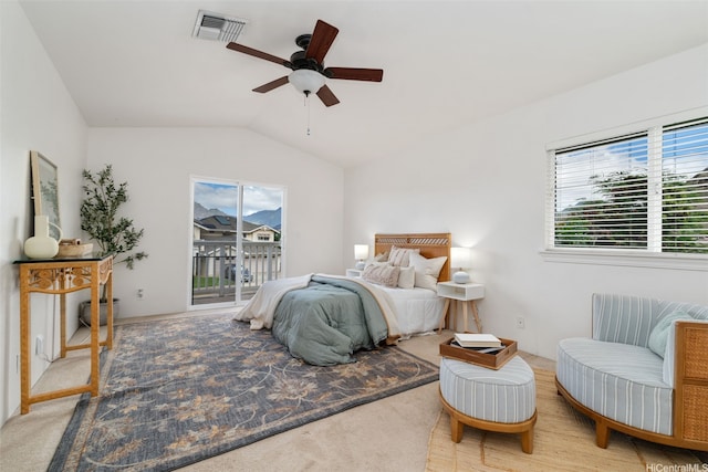 bedroom with multiple windows, lofted ceiling, visible vents, and access to exterior