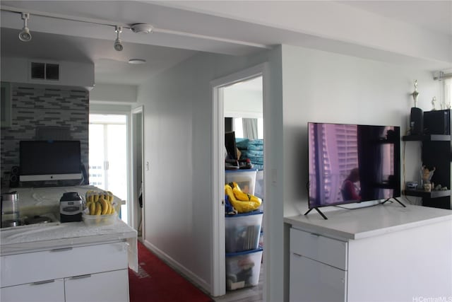kitchen with white cabinets, modern cabinets, light countertops, and visible vents
