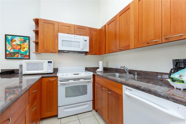 229 Paoakalani Ave Unit 3801, Honolulu, HI 96815 - kitchen featuring brown cabinetry, dark stone countertops, a sink, and white appliances