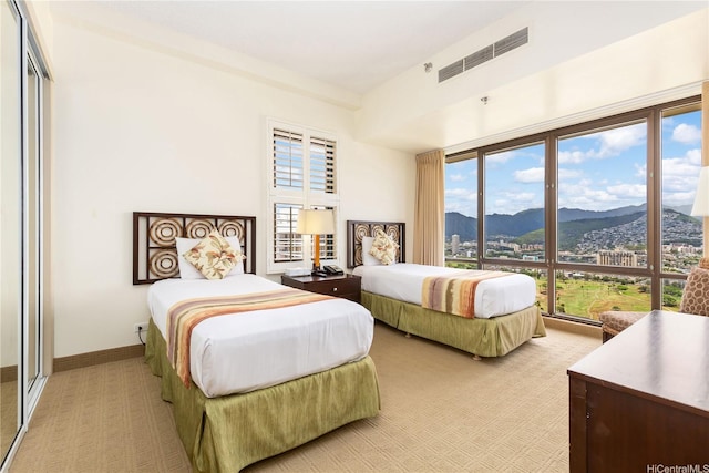 229 Paoakalani Ave Unit 3801, Honolulu, HI 96815 - bedroom with multiple windows, visible vents, light colored carpet, and a mountain view