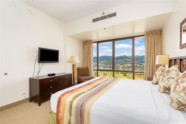 229 Paoakalani Ave Unit 3801, Honolulu, HI 96815 - bedroom with light carpet, baseboards, and visible vents