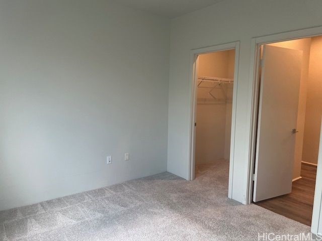 91-3575 Iwikuamoo St Unit 509, Ewa Beach, HI 96706 - unfurnished bedroom with carpet flooring, a spacious closet, and a closet