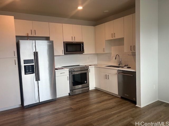 91-3575 Iwikuamoo St Unit 509, Ewa Beach, HI 96706 - kitchen with appliances with stainless steel finishes, dark wood finished floors, light countertops, a sink, and tasteful backsplash