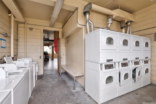 2977 Ala Ilima St Unit 805, Honolulu, HI 96818 - common laundry area with washing machine and clothes dryer, concrete block wall, and stacked washing maching and dryer