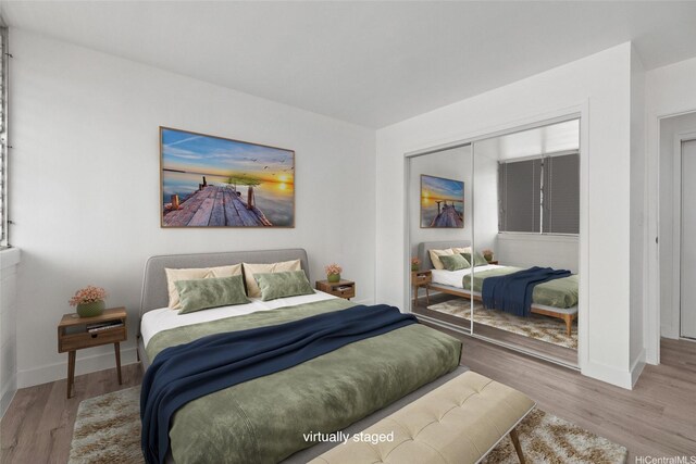 2977 Ala Ilima St Unit 805, Honolulu, HI 96818 - bedroom with baseboards, wood finished floors, and a closet
