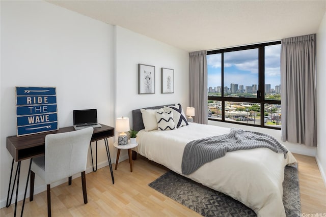 3138 Waialae Ave Unit 918, Honolulu, HI 96816 - bedroom with light wood-style flooring and expansive windows
