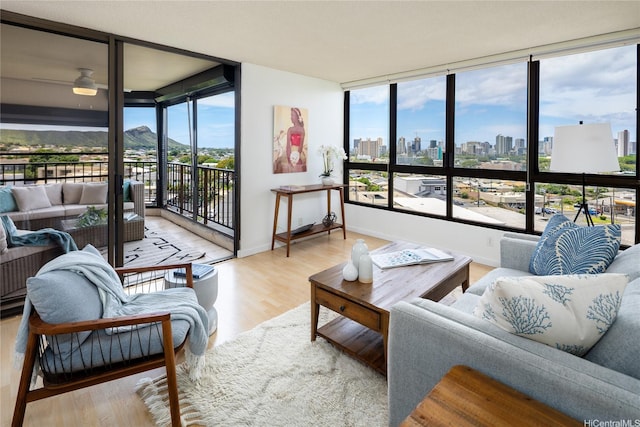 3138 Waialae Ave Unit 918, Honolulu, HI 96816 - living room featuring a skyline view, wood finished floors, floor to ceiling windows, healthy amount of natural light, and a ceiling fan