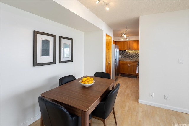 3138 Waialae Ave Unit 918, Honolulu, HI 96816 - dining room with light wood finished floors, baseboards, and track lighting