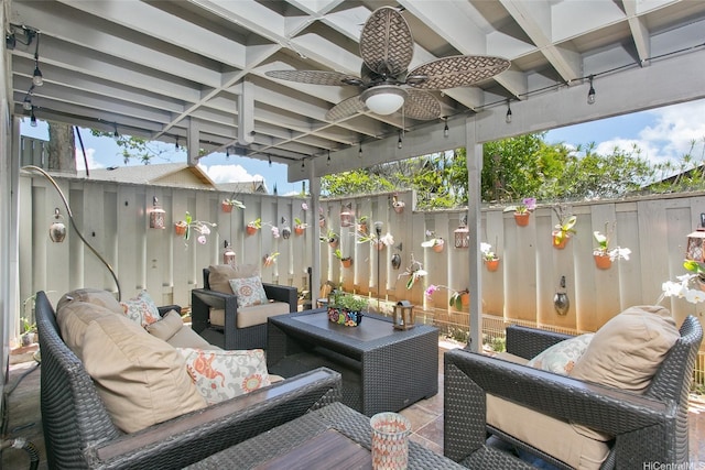 view of patio with an outdoor living space, ceiling fan, and fence