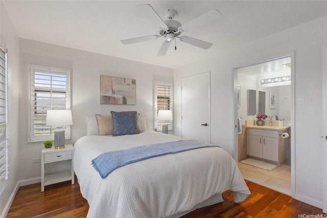 3075 Ala Poha Pl Unit 1509, Honolulu, HI 96818 - bedroom featuring wood finished floors, a sink, ceiling fan, ensuite bath, and baseboards