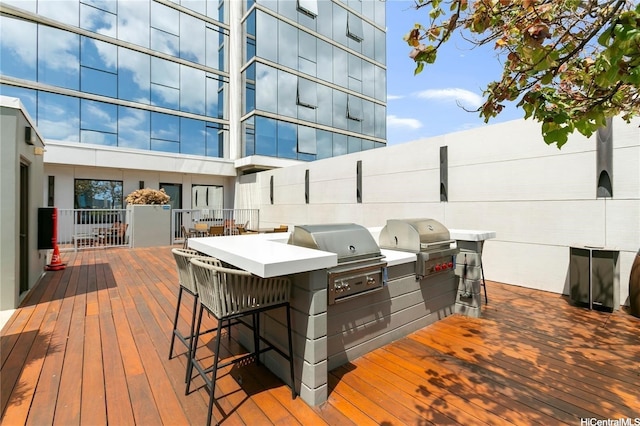 deck with outdoor wet bar, an outdoor kitchen, and area for grilling