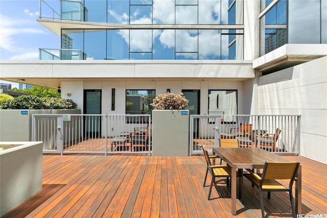 wooden terrace featuring outdoor dining space