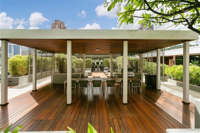 wooden deck with grilling area and outdoor dining area
