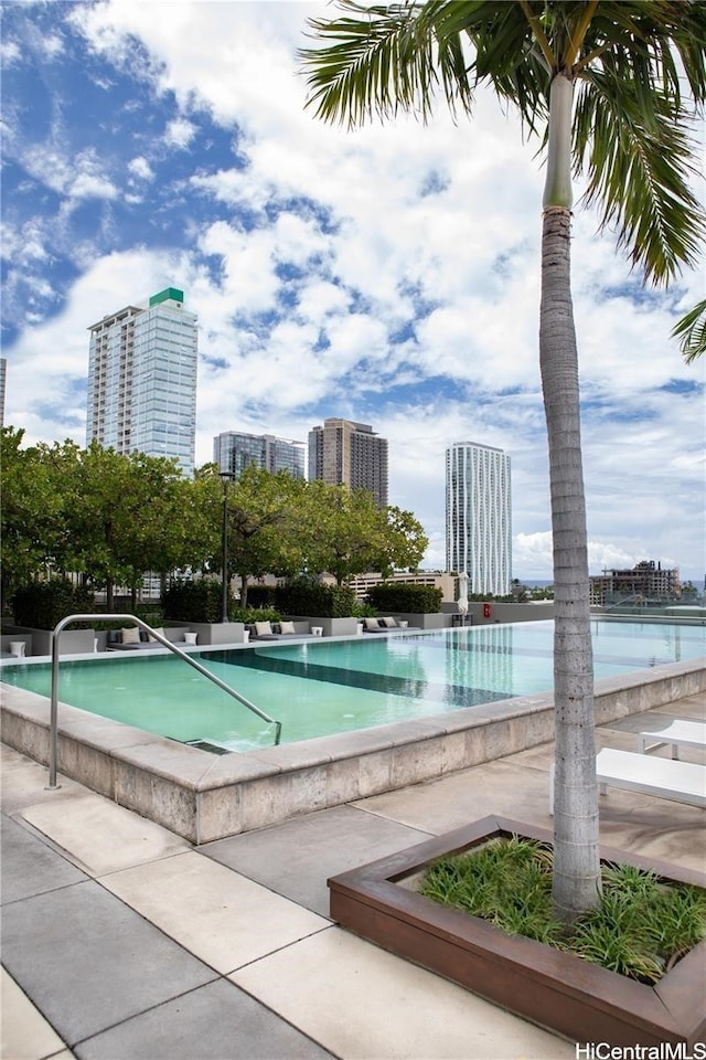 view of swimming pool featuring a city view