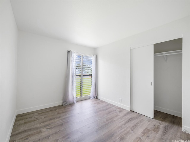 94-615 Kahakea St Unit 9G, Waipahu, HI 96797 - unfurnished bedroom featuring baseboards, a closet, and wood finished floors
