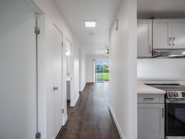 94-615 Kahakea St Unit 9G, Waipahu, HI 96797 - hallway with baseboards and dark wood finished floors