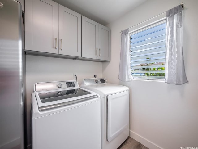 94-615 Kahakea St Unit 9G, Waipahu, HI 96797 - laundry area featuring cabinet space, washing machine and dryer, wood finished floors, and baseboards