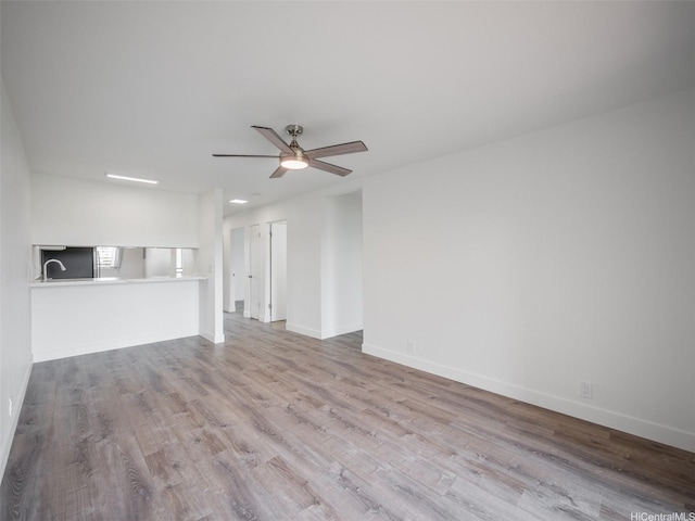 94-615 Kahakea St Unit 9G, Waipahu, HI 96797 - unfurnished living room with a ceiling fan, baseboards, and wood finished floors
