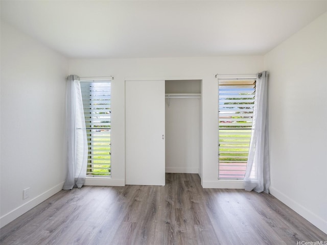 94-615 Kahakea St Unit 9G, Waipahu, HI 96797 - unfurnished bedroom featuring baseboards, a closet, and wood finished floors