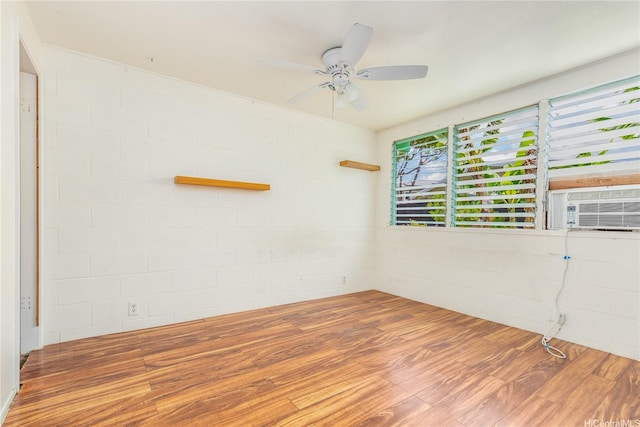 1182 Lauloa St, Kailua, HI 96734 - spare room featuring ceiling fan, wood finished floors, concrete block wall, and cooling unit