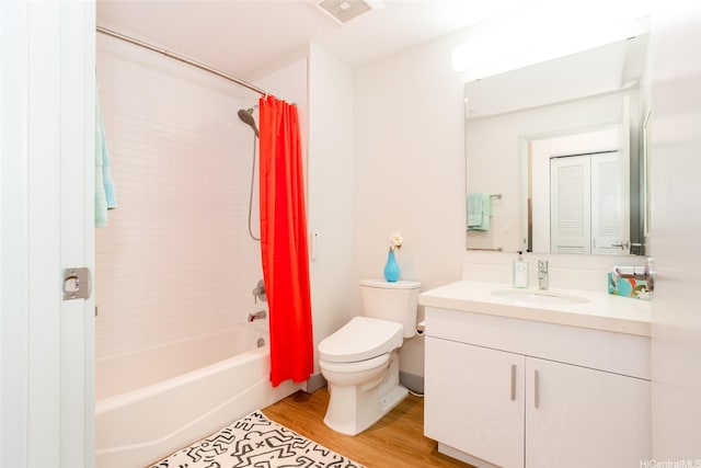 full bath with wood finished floors, visible vents, toilet, vanity, and shower / bath combo