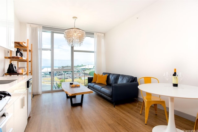 living area with light wood-type flooring, floor to ceiling windows, and a wealth of natural light