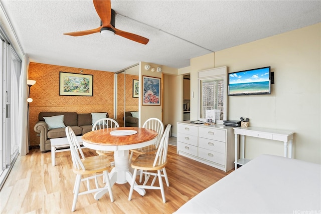 2427 Kuhio Ave Unit 2205, Honolulu, HI 96815 - dining room with a ceiling fan, a textured ceiling, and light wood-style floors