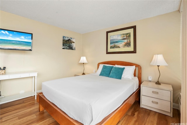 2427 Kuhio Ave Unit 2205, Honolulu, HI 96815 - bedroom featuring baseboards and wood finished floors