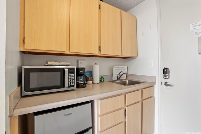 2427 Kuhio Ave Unit 2205, Honolulu, HI 96815 - kitchen featuring light brown cabinetry, light countertops, a sink, stainless steel microwave, and fridge