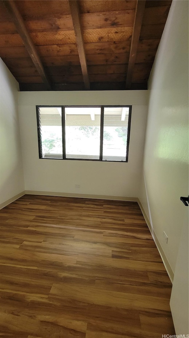 empty room featuring baseboards, wooden ceiling, and wood finished floors