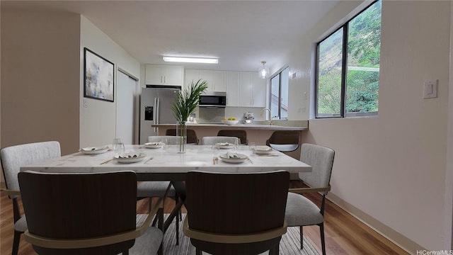 dining room featuring baseboards and wood finished floors