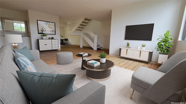 living area featuring baseboards, wood finished floors, and stairs