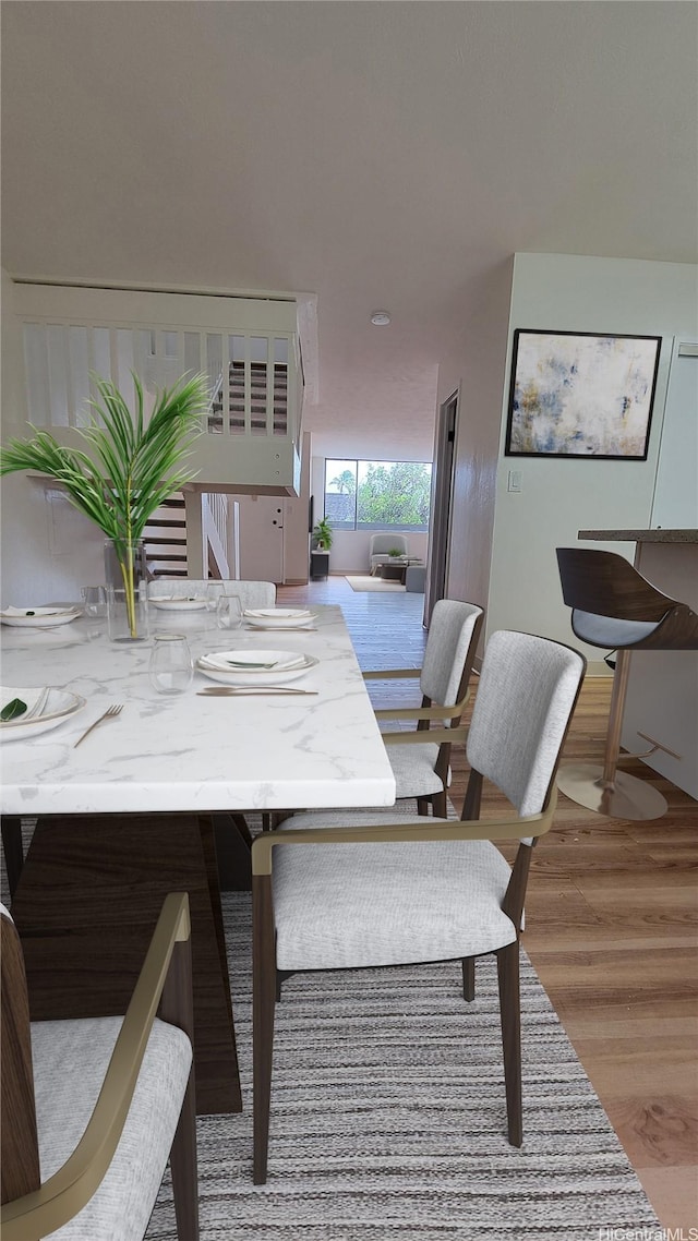 dining space with wood finished floors