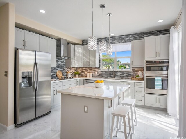 91-1075 Lanakoi St, Kapolei, HI 96707 - kitchen featuring appliances with stainless steel finishes, wall chimney exhaust hood, light marble finish flooring, a sink, and decorative backsplash
