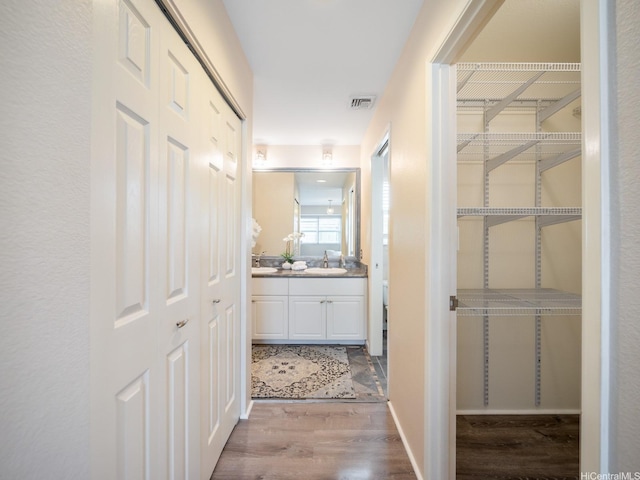 91-1075 Lanakoi St, Kapolei, HI 96707 - hallway featuring a sink and wood finished floors