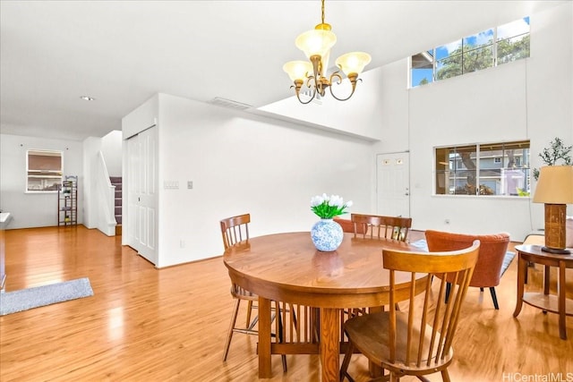 94-513 Kaikua Pl, Waipahu, HI 96797 - dining space featuring visible vents, light wood-style floors, a towering ceiling, and an inviting chandelier