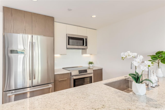 kitchen with recessed lighting, tasteful backsplash, stainless steel appliances, and modern cabinets