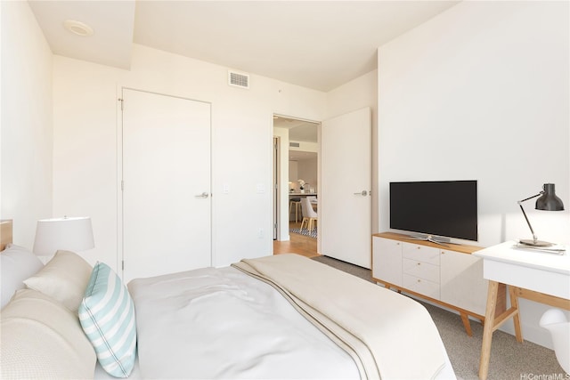 bedroom with light carpet and visible vents