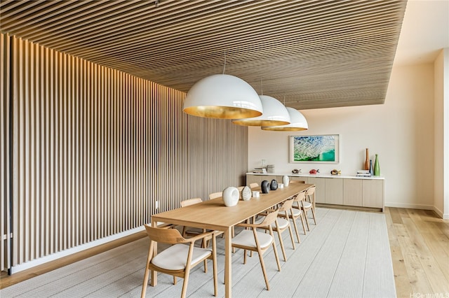 dining area featuring light wood-type flooring and baseboards