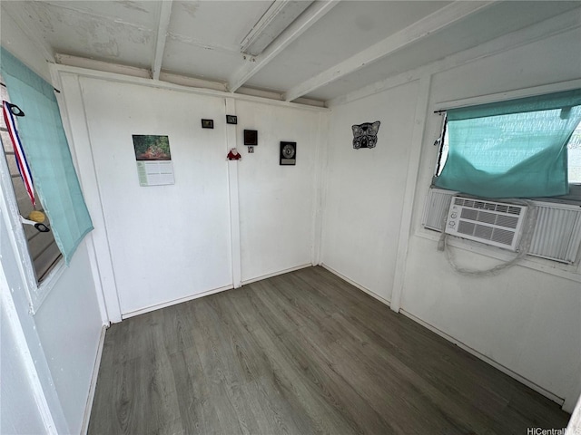 spare room with baseboards, wood finished floors, and cooling unit