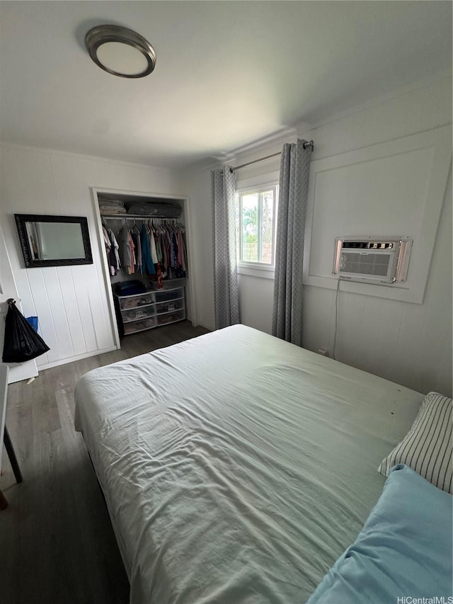 bedroom featuring wood finished floors and a closet