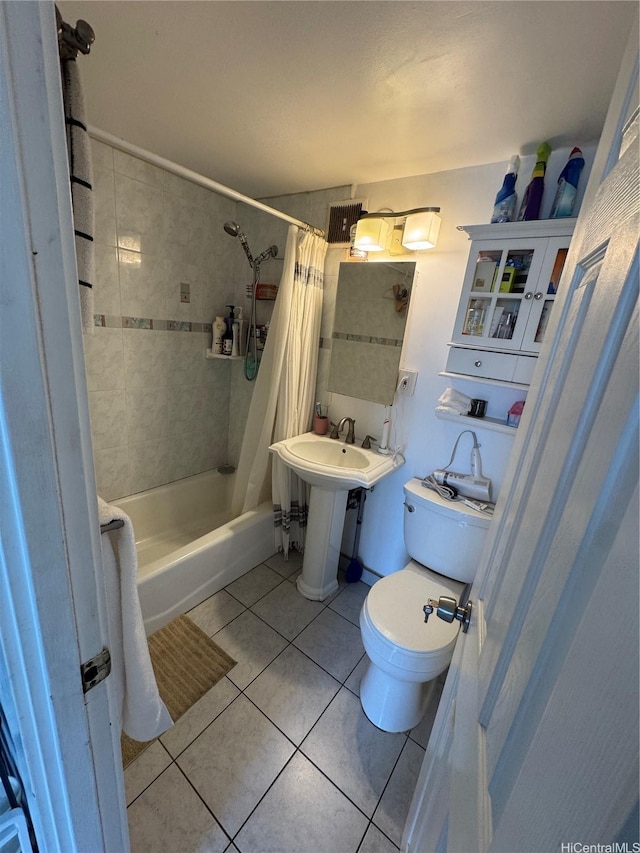 bathroom with shower / tub combo with curtain, toilet, and tile patterned flooring