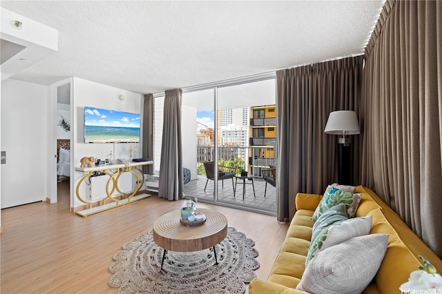 2427 Kuhio Ave Unit 906, Honolulu, HI 96815 - living area with floor to ceiling windows, wood finished floors, and a textured ceiling